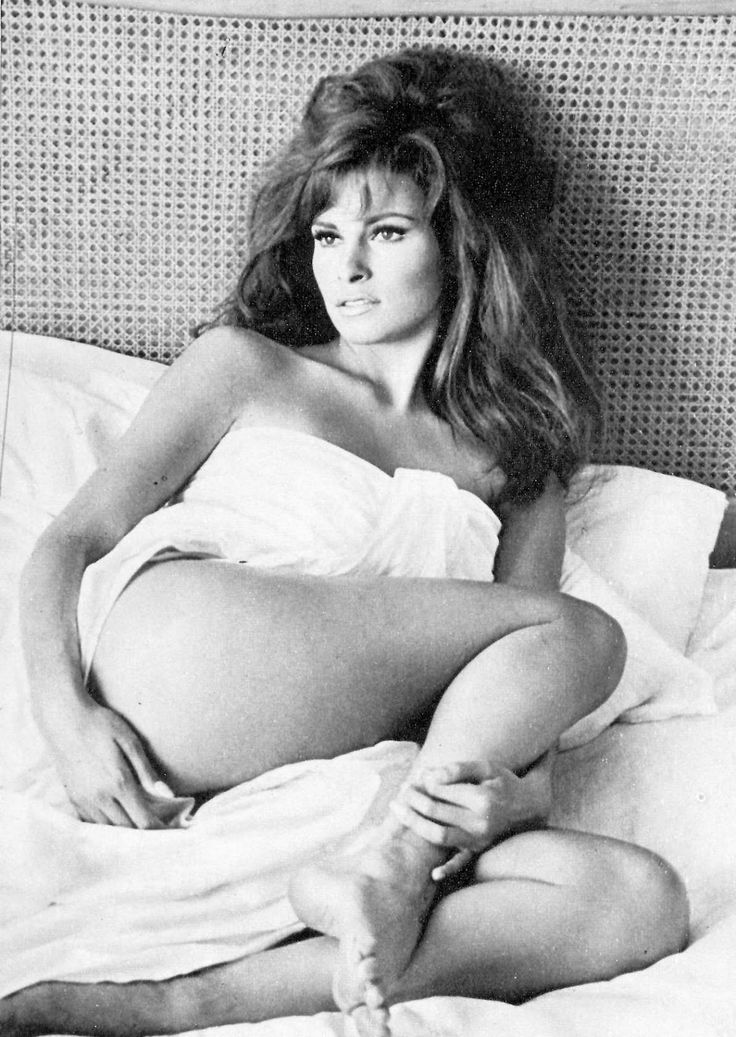Raquel Welch Nude Posing On The Bed And Holding Her Leg