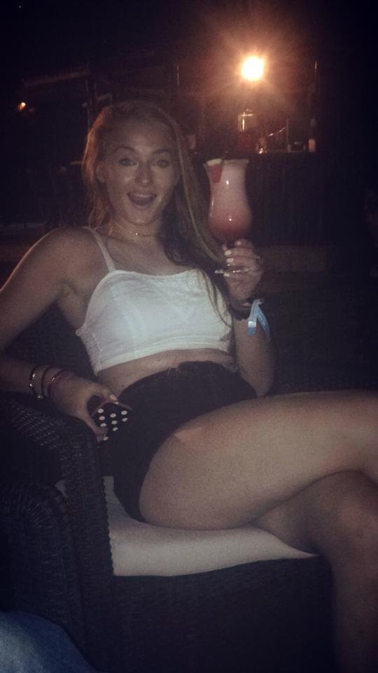 Sophie Turner Nude Legs in Short Skirt While Drinking Cocktail
